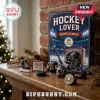 Hockey Lover Ornament Advent Calendar 2026 featuring 24 acrylic hockey-themed miniatures on a wooden fireplace mantle.