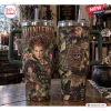 Two 40oz Stanley tumblers showing Winifred Sanderson and Salem-themed graphics on a rustic wooden table.