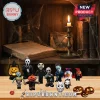 Horror Movie Character 2026 Halloween Advent Calendar featuring miniature iconic villains on a wooden surface with a candle.