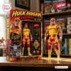 Front view of Hulk Hogan Hulkamania WWE Legend Action Figure standing beside its yellow and red packaging box on a wooden surface.