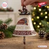 Hand holding an Indian Motorcycle 125th Anniversary bell ornament with a motorcycle topper against a holiday background.