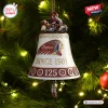 Close up of an Indian Motorcycle 125th Anniversary bell ornament hanging on a lit Christmas tree.
