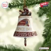 Front view of an Indian Motorcycle 125th Anniversary bell ornament hanging from a pine tree branch.