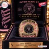 Front view of an Inter Miami CF 2024 Championship Commemorative Ring centered inside a branded display case.