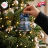 Jaws 50th Anniversary 1975-2025 Bell Ornament featuring a shark, boat, and quote hanging on a festive green pine tree.