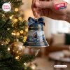 Jaws 50th Anniversary 1975-2025 bell ornament with shark graphic, navy blue ribbon, and hanging shark tooth charm.