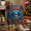 Jaws Advent Calendar 2026 featuring a shark illustration, red ribbons, and cinematic movie memorabilia on a wooden table.