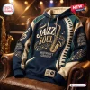 Front view of a blue and beige Jazz Soul Midnight Groove Piano Hoodie resting on a leather armchair.