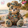 Front view of a Jimmy Buffett Plush Teddy Bear wearing a tropical hat and sitting on a sandy beach.