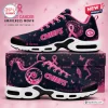 Side view of Kansas City Chiefs breast cancer awareness sneakers with pink ribbons and dandelion motifs.