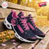 Side view of Kansas City Chiefs breast cancer awareness sneakers on a wooden bench.