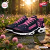 Side view of Kansas City Chiefs Air Max Plus sneakers with pink ribbon motifs outdoors on stone path.