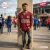 Front view of a man wearing a red distressed Kansas City Chiefs football t-shirt standing near a stadium.