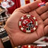 Kansas City Chiefs NFL Poker Set chip featuring a red helmet logo, gold trim, and embedded crystals in a palm.