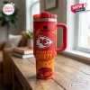 Front view of a Kansas City Chiefs red 40 oz Stanley tumbler on a wooden table.