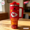Front view of a red Kansas City Chiefs 40 Oz Stanley Tumbler with handle on wooden table.