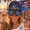 Close-up of a person wearing a distressed denim cap featuring concert imagery and text branding.