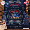 Front view of a distressed denim cap featuring concert graphics of two musicians and the Vibe Room 2027 tour branding.