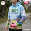 Front view of a Kirby and the World Beyond Blue Sky hoodie featuring a pink character graphic on a scenic landscape print.