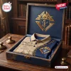 Folded Knights of Columbus Crusader Knight polo shirt inside a dark blue wooden presentation box on a desk.