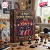 Kpop Demon Hunters 2026 Advent Calendar box featuring chibi character illustrations, surrounding miniature figurines on a desk.