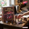 Kpop Demon Hunters 2026 Advent Calendar box featuring chibi character art and 24 miniature collectible figures on a desk.