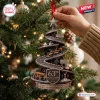 McLaren 63rd Anniversary Christmas ornament features a spiraling racetrack with miniature F1 cars on a pine tree branch.
