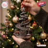 McLaren 63rd Anniversary Christmas ornament featuring a spiral race track design, F1 cars, and a podium in grey and orange.