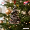 McLaren 63rd Anniversary Christmas ornament featuring a spiral racing track, Formula 1 cars, and a podium on a pine branch.