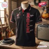 Front view of black polo shirt featuring electric guitar graphic and vertical ROCK lettering.