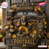 Michigan Wolverines Football Decorative Wreath featuring a central mascot, mini helmets, and stadium scene with team colors.