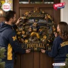 Michigan Wolverines Football Decorative Wreath featuring a mascot, mini helmets, and stadium backdrop on a wooden door.