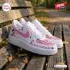 Side view of Mickey Mouse Breast Cancer Awareness Air Force 1 sneakers placed on a wooden bench.