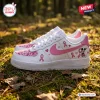 Side view of Mickey Mouse Breast Cancer Awareness Air Force 1 Sneakers featuring pink ribbons and heart motifs on grass.