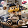 Front view of Milwaukee Brewers mascot plush pillow holding a pennant and baseball on a wooden desk.