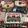 Top view of Monopoly Notre Dame Fighting Irish Collector Edition board game with cards, tokens, and playing board components.