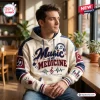 Man wearing a cream colored Music Is My Medicine Patch Pullover Hoodie with blue and maroon accents.