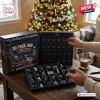 New England Patriots Christmas Advent Calendar 2026 with 24 numbered doors and team-themed ornaments on a wooden table.
