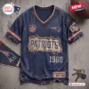 Front view of a blue New England Patriots football t-shirt with distressed, weathered texture and frayed edges.