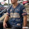Front view of a person wearing a blue New England Patriots NFL football distressed t-shirt with torn fabric details.