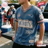 Front view of a distressed blue New England Patriots football t-shirt worn by a person near a truck.