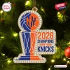 Front view of a New York Knicks 2026 NBA Champions acrylic ornament with faux rhinestone detailing on a tree.
