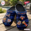 Close-up of New York Knicks blue camo clogs with basketball charms.