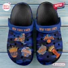 Top view of New York Knicks blue camo clogs decorated with team logo charms.
