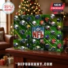 NFL Advent Calendar 2026 featuring 24 numbered grid squares, team helmets, and a central NFL shield on a green field background.