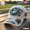 Front view of an NFL Philadelphia Eagles Distressed Baseball Cap resting on a wooden bench.