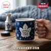 NHL Toronto Maple Leafs 2026 Advent Calendar ceramic mug featuring blue background, white leaf logo, and snowflake patterns.