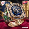 Closeup of a gold Notre Dame Fighting Irish 139th Anniversary Ring featuring a large blue stone and collegiate emblems.