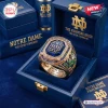 Closeup of a gold Notre Dame Fighting Irish 139th Anniversary Ring inside a blue presentation box.
