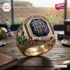 Close-up of a Notre Dame Fighting Irish 139th Anniversary Ring featuring a large blue stone and collegiate details.